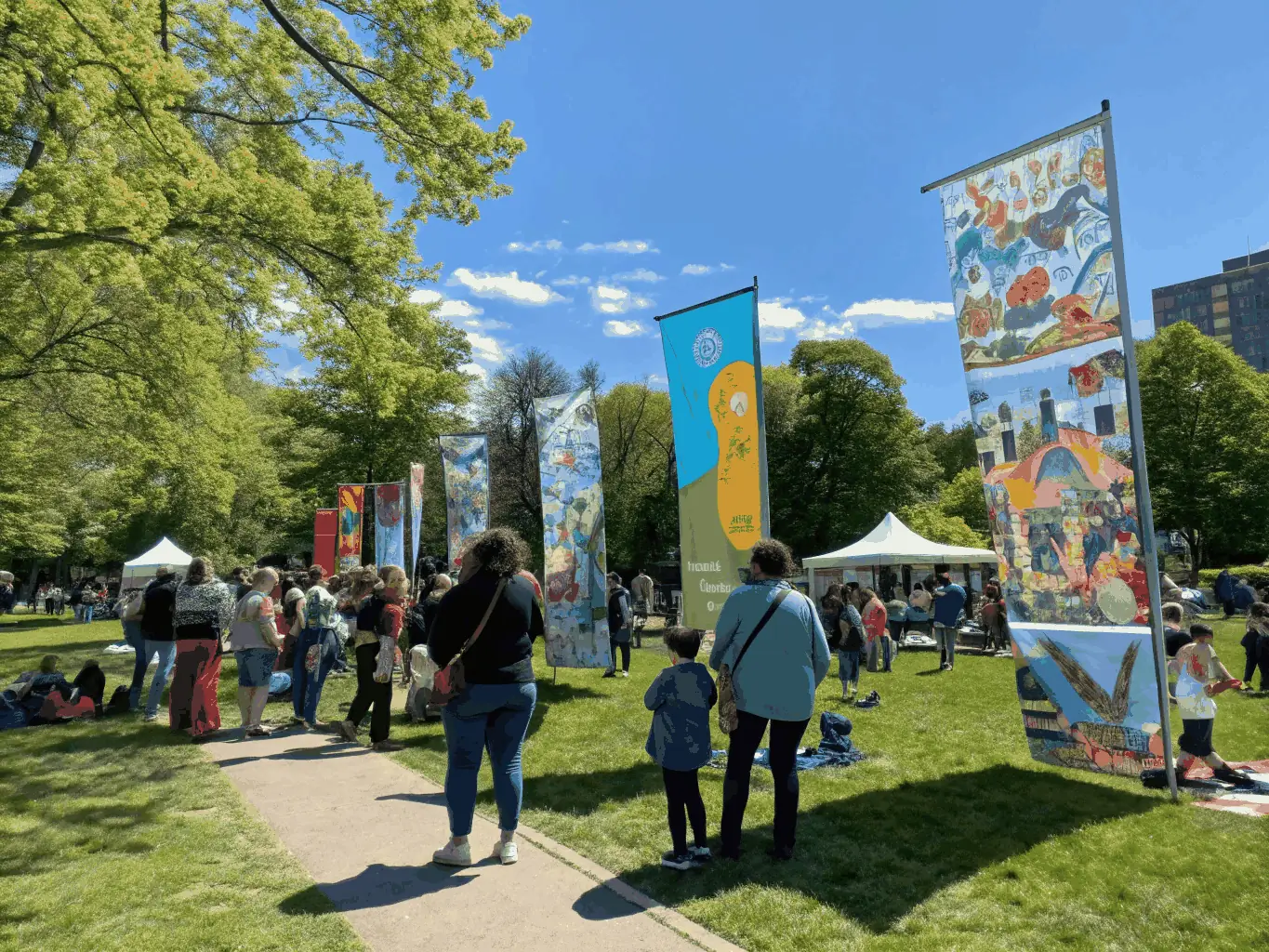 A community gathering in an outdoor cultural event with diverse participants engaging in activities, illustrating CASHEW PRODUCTION's commitment to cultural diffusion and community engagement.